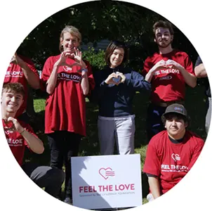 Community member holding a Feel the Love nomination sign