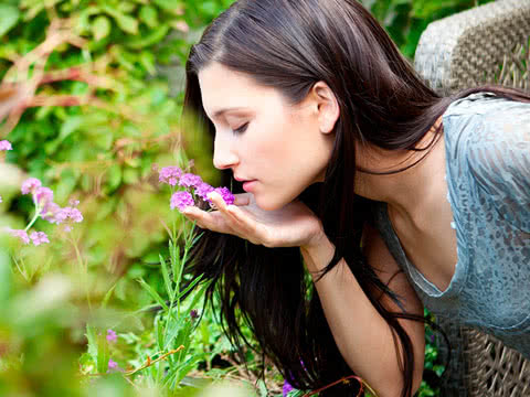 A woman smelling a flower